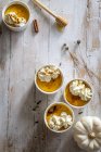 Small pumpkin cheesecakes with whipped cream — Stock Photo