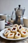 German cookies (butter biscuits filled with jam) served with coffee — Stock Photo