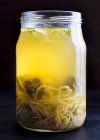 Chicken soup with liver dumplings and egg noodles in a glass jar — Stock Photo