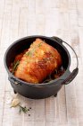 Rolled roasted pork belly in Dutch oven cooking pot — Stock Photo
