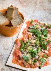 Marinated salmon with capers, cheese and arugula — Stock Photo