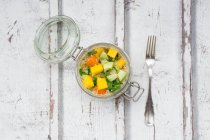Quinoa salad with avocado, cucumber, tomato and mango in glass jar — Stock Photo