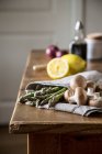 Espargos verdes e cogumelos marrons na toalha de cozinha — Fotografia de Stock