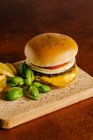 Cheese and beef burger with mustard barbecue sauce and french fries — Stock Photo