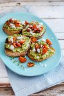 Bruschetta's with courgettes pesto, roasted tomatoes, feta cheese and thyme — Stock Photo