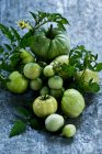 Fresh green tomatoes on a wooden background — Stock Photo