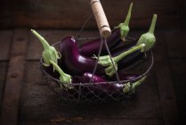 Fresh ripe red eggplants on rustic wooden background. — Stock Photo