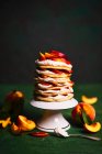 Pancakes cake with sweet creamy cheese and peaches — Stock Photo