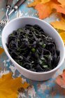 Black noodles with oil and parsley — Stock Photo