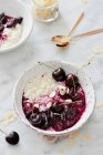 Rice pudding with cherries and flaked almonds — Stock Photo