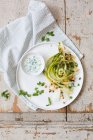 Raw asparagus strips with a herb dip — Stock Photo