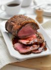 A joint of roast beef, sliced — Stock Photo