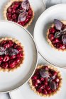 Cherry tartlets with red basil — Stock Photo