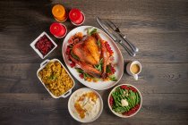 Roast turkey with orange glaze and side dishes — Stock Photo