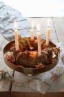 A traditional advent wreath on a golden stand with a hand painted label on a rustic table — Stock Photo