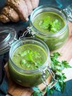 Vegan cream of baked zucchini, sweet potato and spinach soup served in mason jars — Stock Photo