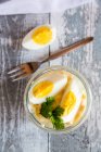 Eggs salad in glass jar with fork — Stock Photo