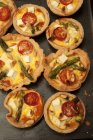 Asparagus, tomato, feta and pine nut tarts (seen from above) — Stock Photo