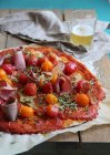 Pizza with ham, cherry tomatoes and thyme — Stock Photo