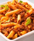 Penne Bolognese pasta with sauce and basil — Stock Photo