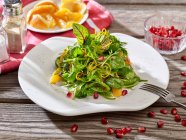 Wild herbs salad with oranges and pomegranate seeds — Stock Photo