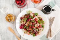Lettuce with chicken and cherries, top view — Stock Photo