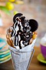 A bubble waffle with frozen yoghurt, Oreo cookies, Oreo popcorn and chocolate sauce — Stock Photo