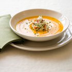 Carrot soup with Dungeness crab in white plate — Stock Photo