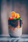 Chia pudding with fresh oranges, chocolate cream, mint and physalis — Stock Photo