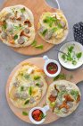 Mini pizzas with mushrooms pear basil white sausage served with tomato sauce — Stock Photo