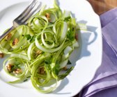 Green asparagus strips with walnuts and herbs — Stock Photo