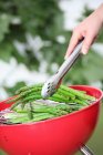 Green asparagus on a round barbecue — Stock Photo