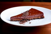 A slice of chocolate tart on a white plate — Stock Photo