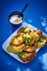 Zucchini and potato fritters with parsley and yoghurt dip — Stock Photo