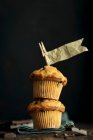 Vanilla muffins with pieces of chocolate and paper flags — Stock Photo