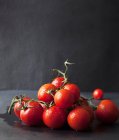 Tomates maduros de vid recién lavados en una pila - foto de stock