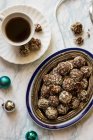Dates and almond truffles, no sugar, cup of coffee, Christmas decorations — Stock Photo