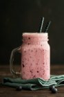 A smoothie with almond milk, berries and bananas in a jar with a handle — Stock Photo