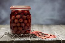 Preserved cherries in a glass jar — Stock Photo