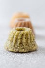 Mini Bundt cakes with pistachio nuts, poppyseeds and icing sugar — Stock Photo