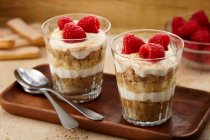 Tiramisu with overnight oats and fresh raspberries in glasses — Stock Photo