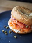 A bagel with salmon, cream cheese, capers and onion — Stock Photo