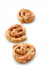 Three apple and cinnamon buns on a white surface — Stock Photo
