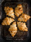 Croissants mit Mandelflocken auf einem Backblech — Stockfoto