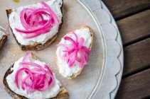 Bruschetta toasted sliced baguette, ciabatta and sourdough bread with mackerel pate and pickled red onion — Stock Photo