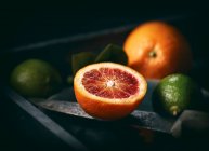 Blood oranges and limes — Stock Photo