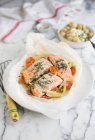 Salmon in parchment paper with fennel and tomatoes — Stock Photo