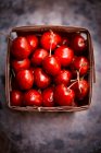 Fresh cherries in a wooden basket (seen from above) — Stock Photo