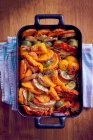 Roasted sweet potatoes and vegetables in an oven dish — Stock Photo