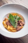 Fresh homemade pappardelle tagliatelle pasta with slow cooked game ragu in red wine and bay leaves garnished with thyme — Stock Photo